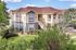 Charming two-story apartment complex surrounded by lush greenery, featuring elegant architecture and inviting balconies.