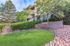 Charming apartment complex with beautifully landscaped greenery and modern architecture, perfect for serene living.