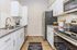 Modern kitchen with sleek stainless steel appliances, elegant white cabinetry, and granite countertops.