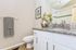 Elegant bathroom with sleek granite countertop, modern fixtures, and stylish decor for a luxurious touch.