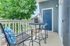 Charming apartment balcony with modern seating, lush greenery, and vibrant decor for a relaxing outdoors experience.