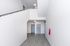 Modern apartment hallway with sleek flooring, contemporary design, and high ceilings creating a spacious and welcoming atmosphere.