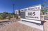 Inviting Struthers Residence sign on a sunny day, showcasing modern apartment complex at 805 Struthers Ave with well-maintained landscaping.