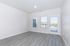 Bright and airy room with modern hardwood flooring and large windows showcasing scenic views, perfect for relaxation and inspiration.