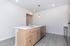 Sleek modern kitchen featuring a large island with elegant pendant lighting and stainless steel appliances.