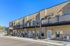 Modern townhomes with upper-level balconies and spacious outdoor area, perfect for enjoying sunny days.