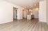 Bright, open-concept living space with modern kitchen island and in-unit laundry, perfect for stylish urban living.