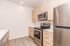 Contemporary kitchen with sleek stainless steel appliances, elegant wooden cabinetry, and spacious countertops for modern living.