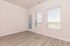 Bright and airy room with modern wood flooring and floor-to-ceiling windows, offering stunning views and natural light.