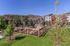 Charming apartment community with scenic mountain views, lush green lawns, and a modern fenced recreation area.