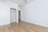 Bright and airy room with sleek hardwood flooring and a spacious closet, perfect for a modern living space.