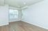 Bright and inviting living space with large windows and elegant wooden flooring, offering picturesque views and ample natural light.