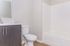Modern bathroom with sleek cabinetry, elegant fixtures, and a spacious shower-tub combo.