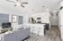 Modern open-concept living area with sleek kitchen, cozy seating, and elegant decor.