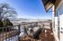 Charming balcony with modern seating offering stunning snow-capped mountain views, perfect for relaxation.