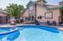 Inviting outdoor pool area with modern amenities, featuring a cozy lounge area and stylish architecture.
