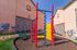 Charming apartment exterior showcasing vibrant playground equipment against a sunny backdrop.
