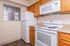 Charming kitchen with modern appliances, warm wooden cabinetry, and sleek countertops offering a cozy cooking experience.