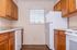 Charming kitchen with rich wooden cabinetry, modern appliances, and ample natural light creating a cozy cooking atmosphere.