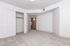 Spacious and bright empty room with plush carpeting, featuring a built-in closet with sliding doors and inviting neutral walls.