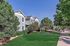 Charming apartment complex with lush green landscaping and modern architecture, perfect for serene living.