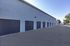 Modern apartment complex featuring multiple secure garages with sleek design and ample parking space.