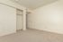 Bright and spacious bedroom featuring plush carpet, a large sliding door closet, and freshly painted walls.