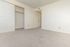 Bright and airy bedroom with plush carpeting and a spacious closet, perfect for a cozy retreat.