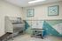 Modern pet grooming facility with stylish geometric artwork, stainless steel wash station, and vibrant wall designs.