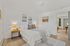 Bright and inviting bedroom with elegant decor, cozy bed, and stylish artwork, perfect for relaxation and comfort.