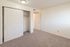 Bright and spacious bedroom with plush carpeting and a generous built-in closet, perfect for modern living.