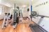 Bright and welcoming apartment fitness center featuring modern exercise equipment and a motivational atmosphere.