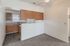 Bright and welcoming kitchen with warm wood cabinets and sleek countertops, ideal for modern living.