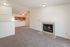Inviting living space with cozy carpeted floors and a stylish fireplace, perfect for relaxation and entertaining.