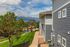 Charming residential view featuring a scenic mountain landscape, modern apartments, and lush greenery, ideal for nature lovers seeking a peaceful neighborhood.
