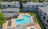 Charming apartment complex with pristine swimming pool and inviting courtyard, perfect for relaxation and leisure.
