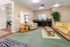 Welcoming living space with cozy seating, vibrant decor, and a kitchenette, perfect for social gatherings.
