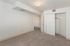 Inviting bedroom with plush carpet, ample closet space, and a soft neutral palette, perfect for personalization.