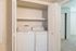 Convenient in-unit laundry area with modern washer and dryer, enhancing apartment living comfort.