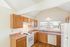 Bright and inviting kitchen with wooden cabinets, modern appliances, and ample counter space, illuminated by natural light.