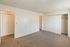 Bright and spacious bedroom with plush carpet, ample closet space, and sleek white doors, perfect for stylish living.