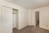 Inviting room with soft carpet flooring, ample closet space, and a crisp white finish perfect for personalization.