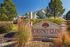 Charming exterior view of Chestnut Glen with lush landscaping and clear blue skies, highlighting an inviting community atmosphere.