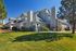 Charming suburban apartment building with landscaped gardens and modern architecture, perfect for comfortable living.