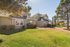 Charming residential property with a spacious lawn and picturesque surroundings, perfect for a tranquil lifestyle.