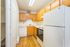 Charming kitchen with wooden cabinetry, sleek appliances, and inviting hardwood floors, perfect for culinary adventures.