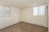 Inviting sunlit room with plush carpet and modern blinds, perfect canvas for your dream space.