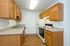 Charming and functional kitchen with warm wooden cabinetry, modern appliances, and ample countertop space.