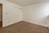 Bright and spacious bedroom with plush carpet and a large closet, perfect for comfort and storage.