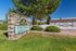 Welcoming Fir Tree apartment homes sign with lush greenery, offering affordable living in a serene setting.